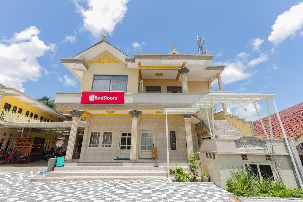 ein Gebäude mit einem Schild davor in der Unterkunft RedDoorz Plus @ Villa Bontes Batu in Batu