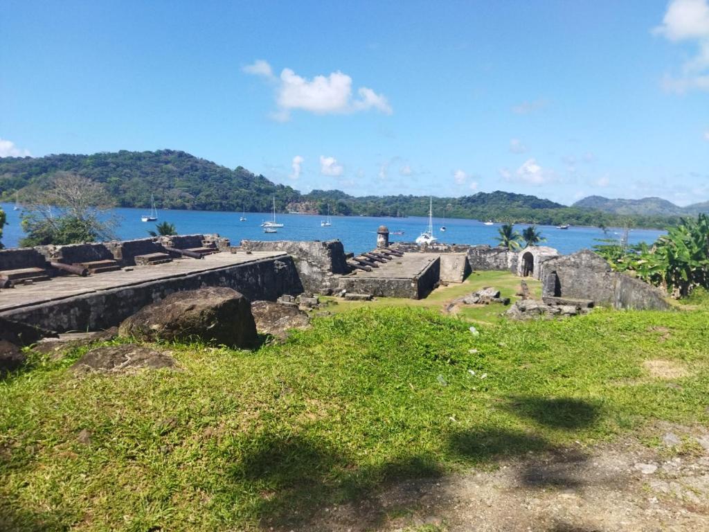 a view of the ruins of the ruins of a castle on the water at Ofiuras Hostal in Colón