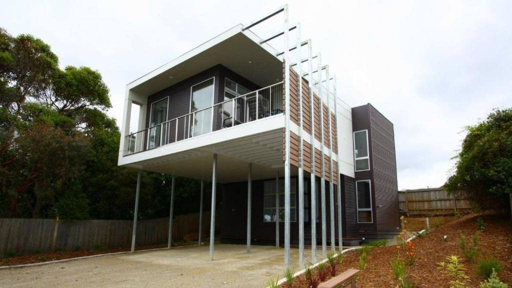 a house with a balcony on the side of it at The Lane House in Apollo Bay