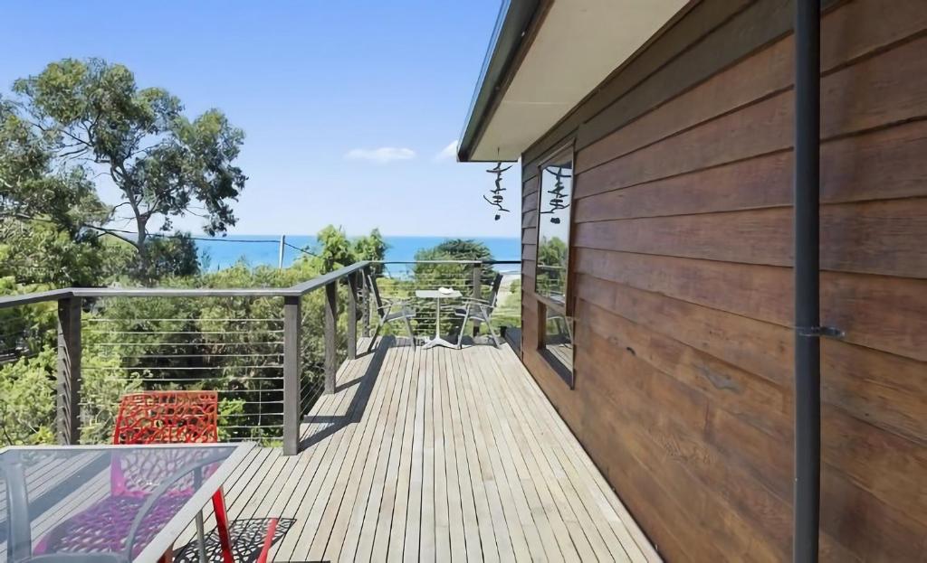 a wooden deck with a view of the ocean at 2 Degrees of Separation in Wye River