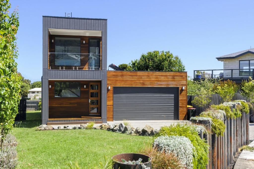 a modern house with a garage in a yard at Scenic Estate in Apollo Bay