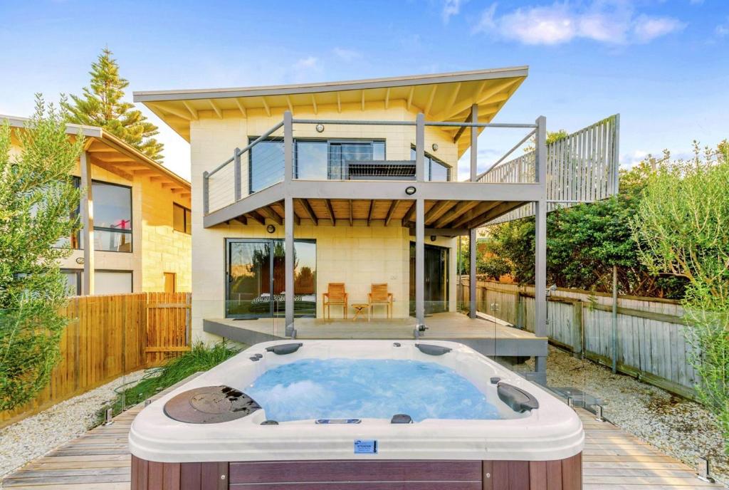 a house with a hot tub in front of a house at Achilles in Apollo Bay