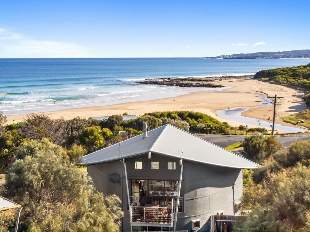 a house on a hill next to a beach at Manta Ray One in Apollo Bay