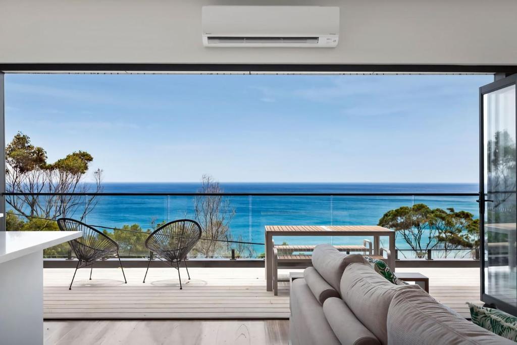 a living room with a view of the ocean at The Cube in Wye River