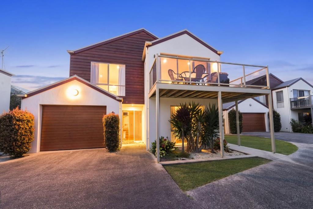 a house with a balcony on top of it at Sound Of The Sea in Apollo Bay