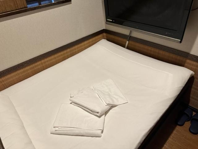 Postel nebo postele na pokoji v ubytování プチホテル　コスモス
