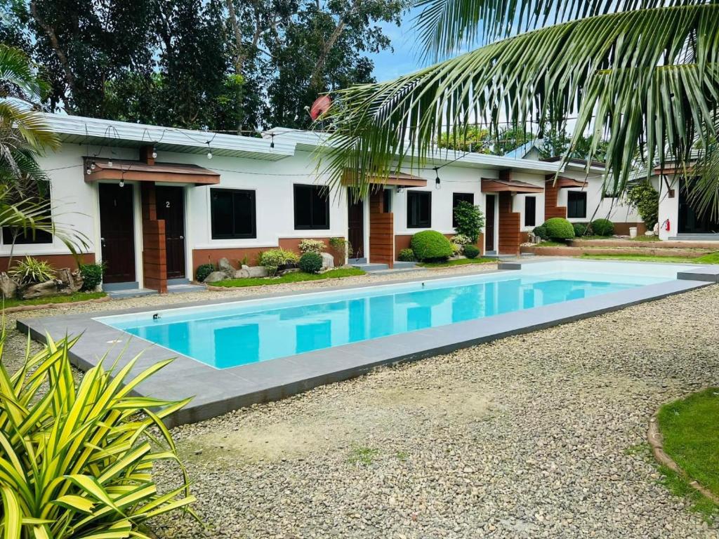 una casa con piscina frente a ella en Ashelma resort, en Dauis
