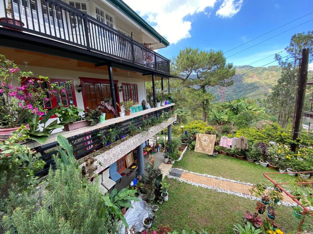 a house with a bunch of potted plants on it at Moss Monterrazas in Itogon