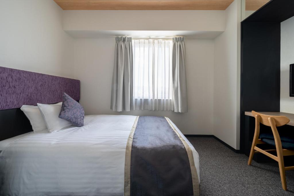 Postel nebo postele na pokoji v ubytování Hotel Vista Hiroshima