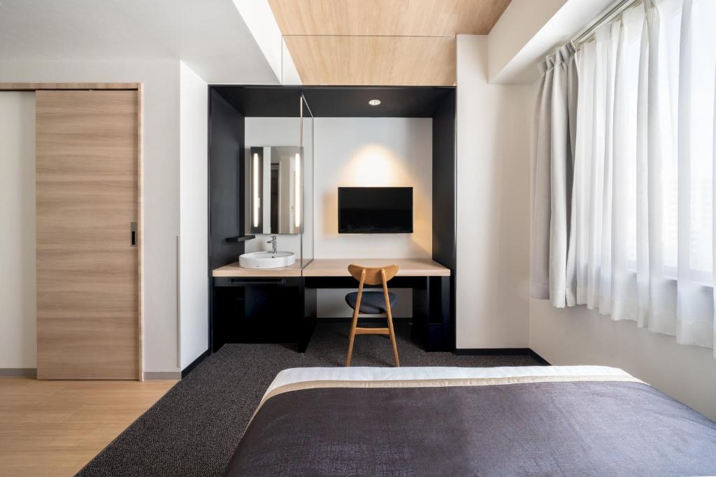 Postel nebo postele na pokoji v ubytování Hotel Vista Hiroshima