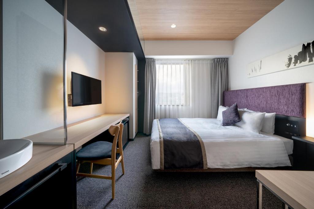 Postel nebo postele na pokoji v ubytování Hotel Vista Hiroshima