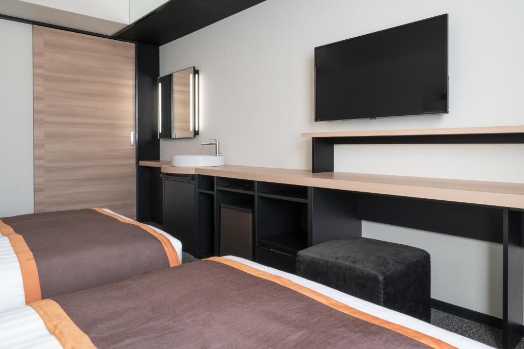 Postel nebo postele na pokoji v ubytování Hotel Vista Hiroshima