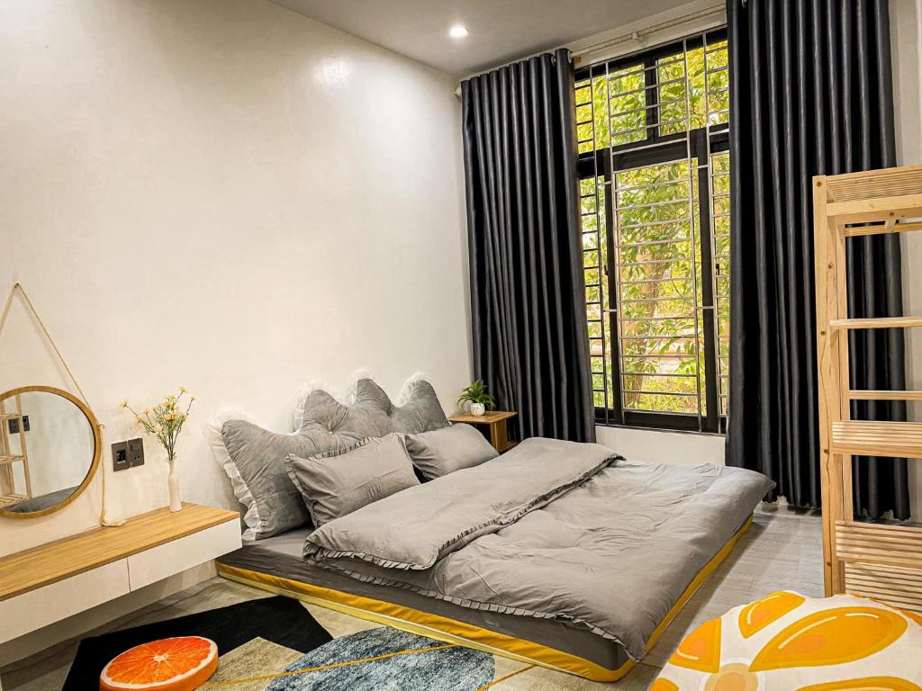 a bed in a room with a large window at KS - Homestay MyLan in Lạng Sơn