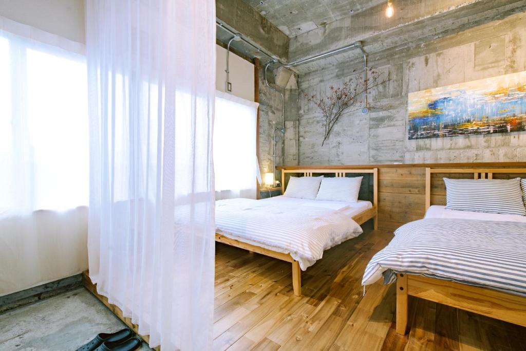 Postel nebo postele na pokoji v ubytování Guesthouse RICO