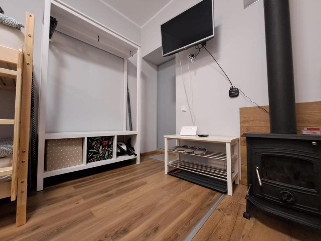 een woonkamer met een open haard en een flatscreen-tv bij Ideal for family and older pers. in Rīga
