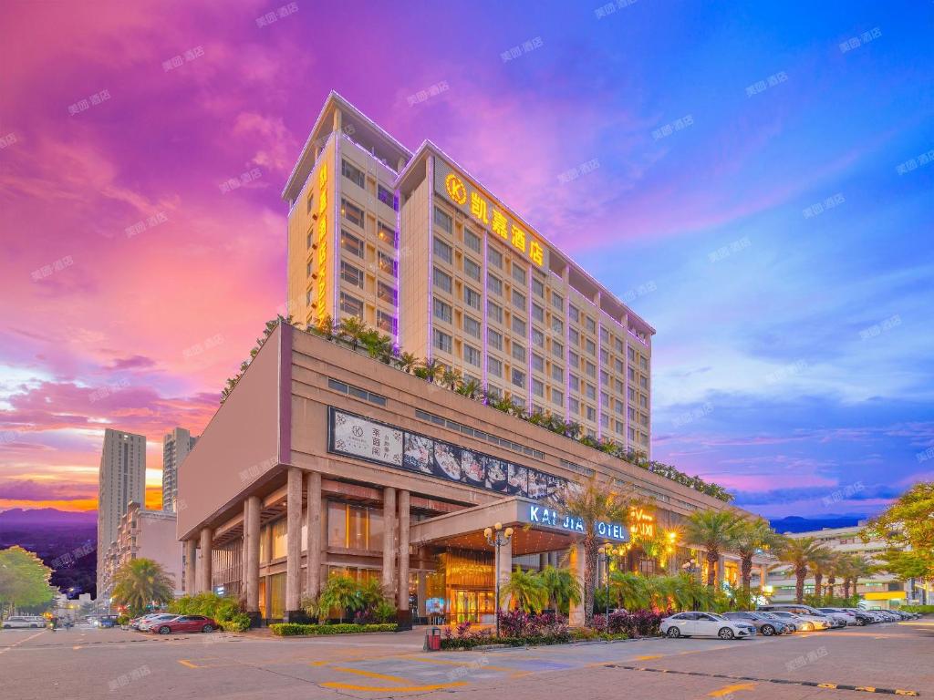 a hotel building with a sign on top of it at Kaijia Hotel in Bao'an