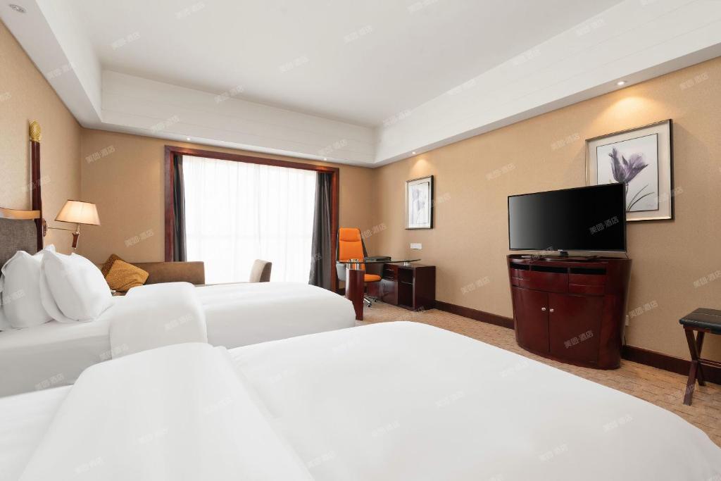 Postel nebo postele na pokoji v ubytování 深圳国际会展中心凯嘉酒店-Shenzhen Kaijia Hotel-Shenzhen-World
