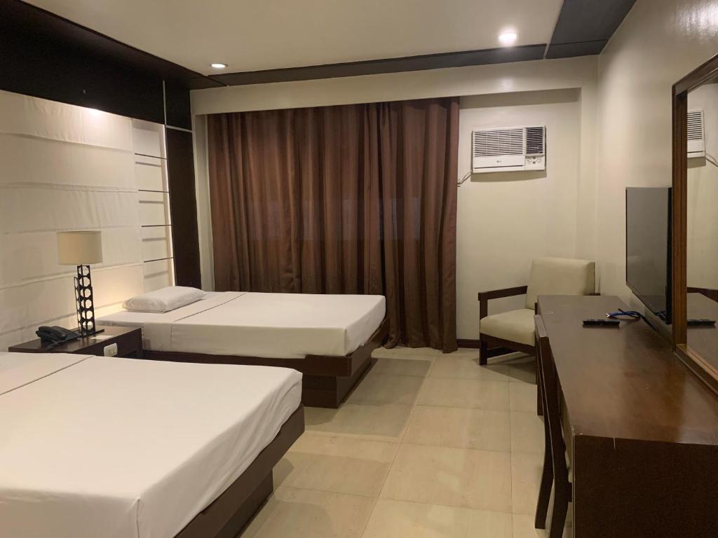 Postel nebo postele na pokoji v ubytování De Luxe Hotel