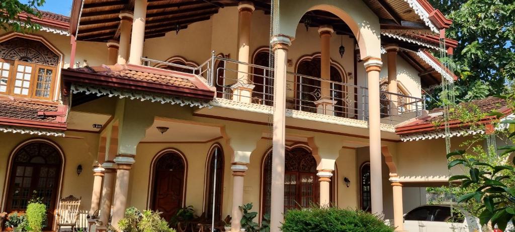 a large house with a balcony on the side of it at Kumudu Home Stay 