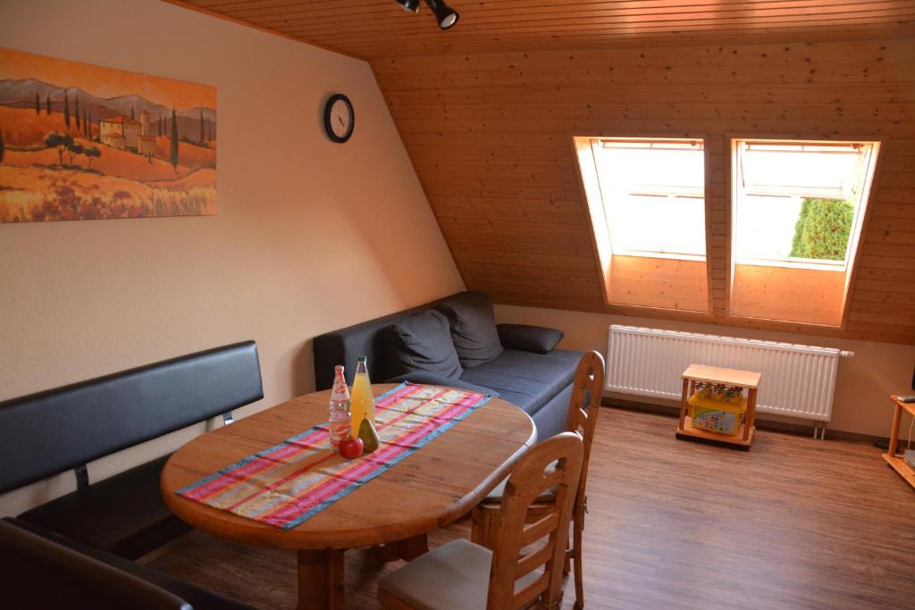 a living room with a table and a couch at Ferienhof-Dachsberg Wohnung Weitblick in Bermatingen