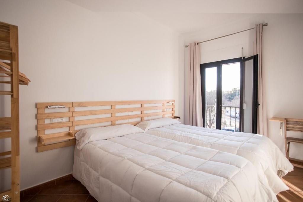 A bed or beds in a room at Hostal Rio