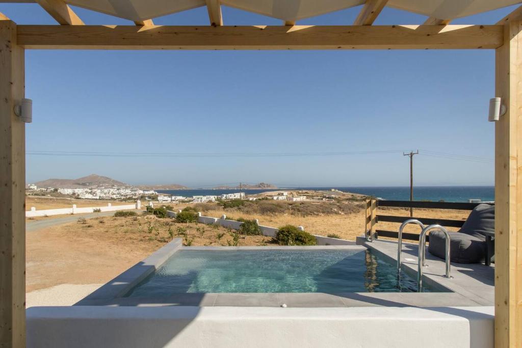 a swimming pool with a view of the ocean at Maisonette Sail in Naousa