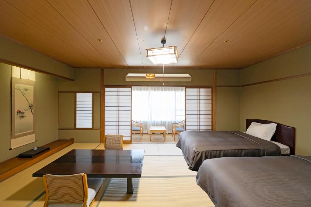 Postel nebo postele na pokoji v ubytování Isawa Tokiwa Hotel