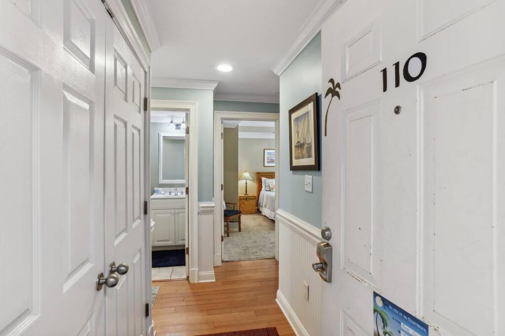 a hallway with a white door and a bedroom at Unique 3BR, 1 of 5 Condos w/Huge Poolside Patio, Steps to Beach & Pier, Gated in Tybee Island