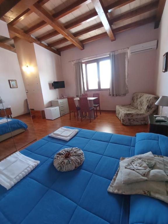 a living room with a blue couch and a table at B&B Da Luca in Grottaminarda
