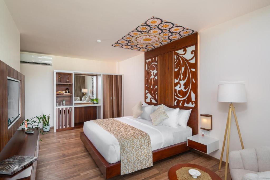 Postel nebo postele na pokoji v ubytování Grand Serendib Hotel