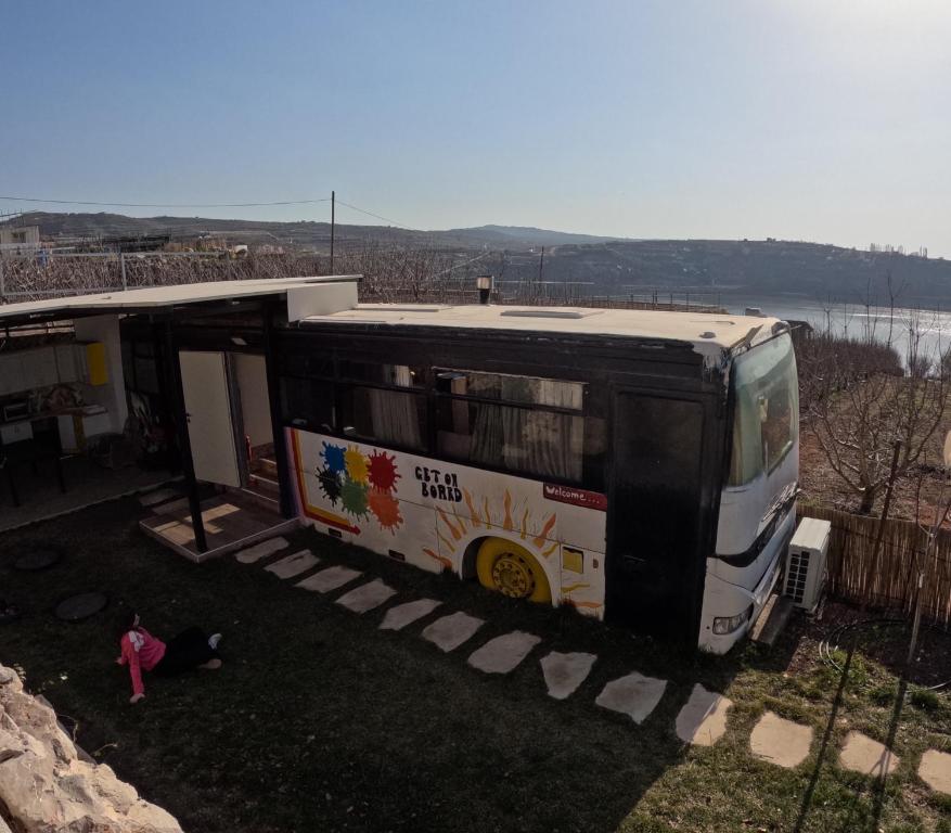 a bus is parked at a bus stop at The Bus in Majdal Shams