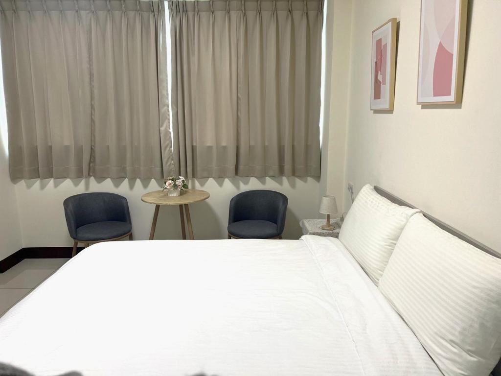 Postel nebo postele na pokoji v ubytování Hourlight Homestay