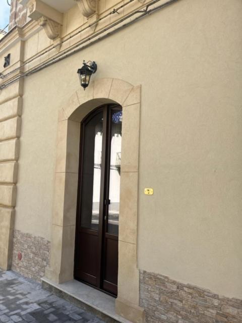 a building with a door with a lamp above it at B&B UNICI GRAMMICHELE in Grammichele