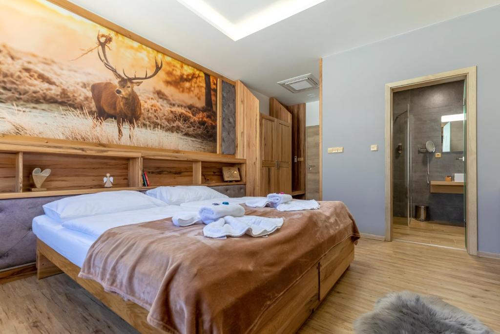 Postel nebo postele na pokoji v ubytování PENZION U MEDVĚDA