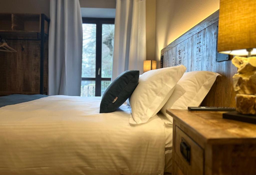 a bedroom with a bed with a pillow on it at Hotel Paradiso Como in Brunate
