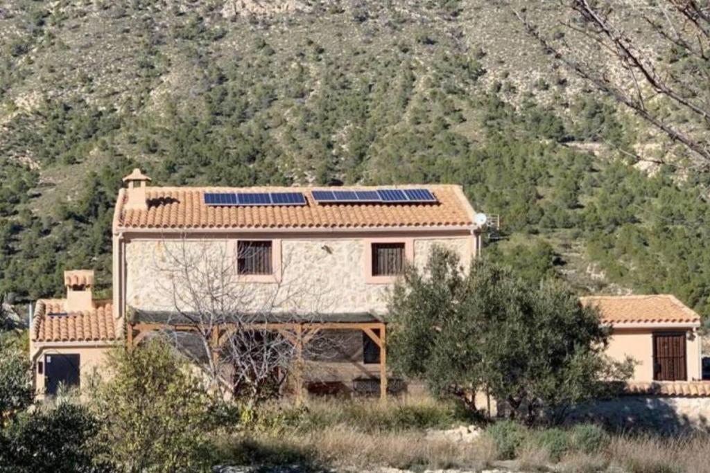 una casa con paneles solares encima en Beautiful 4-Bed House in Campo de Ricote en Collado de Gil