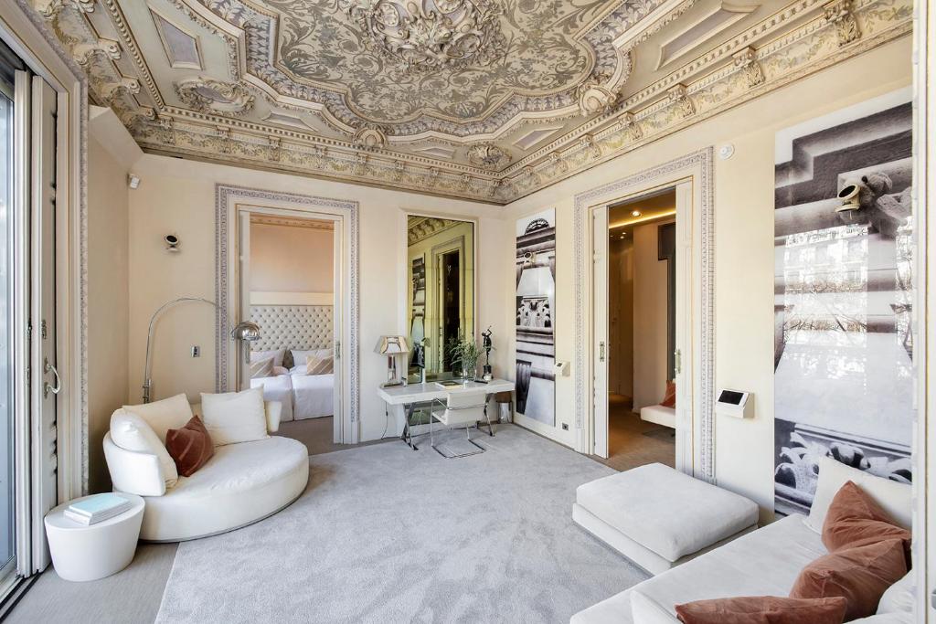 a living room with a coffered ceiling and a couch at El Palauet Royal Suites in Barcelona