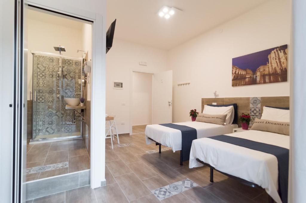Postel nebo postele na pokoji v ubytování RAUDINO ROOMS