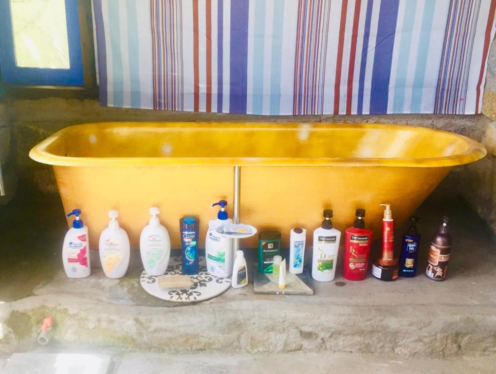 a bath tub with a bunch of bottles of detergent at HEY! STORM HOME in Ấp Ða Lợi