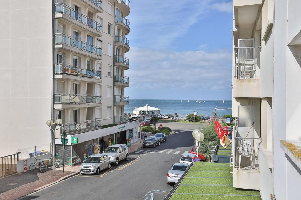 a view of a street from a balcony of a building at Bel appartement à 100m de la plage in Les Sables-d'Olonne