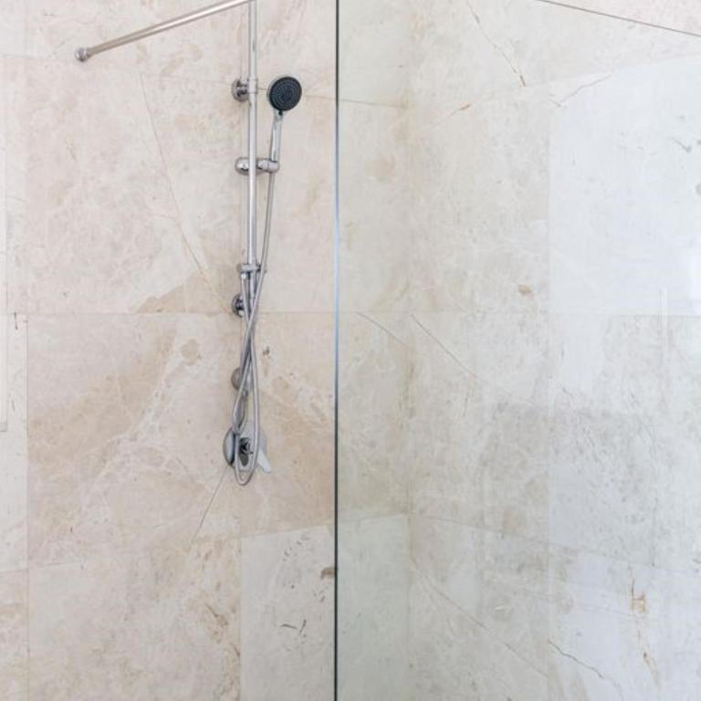 a shower with a glass door in a bathroom at Plaisir Estate Accommodation in Simondium