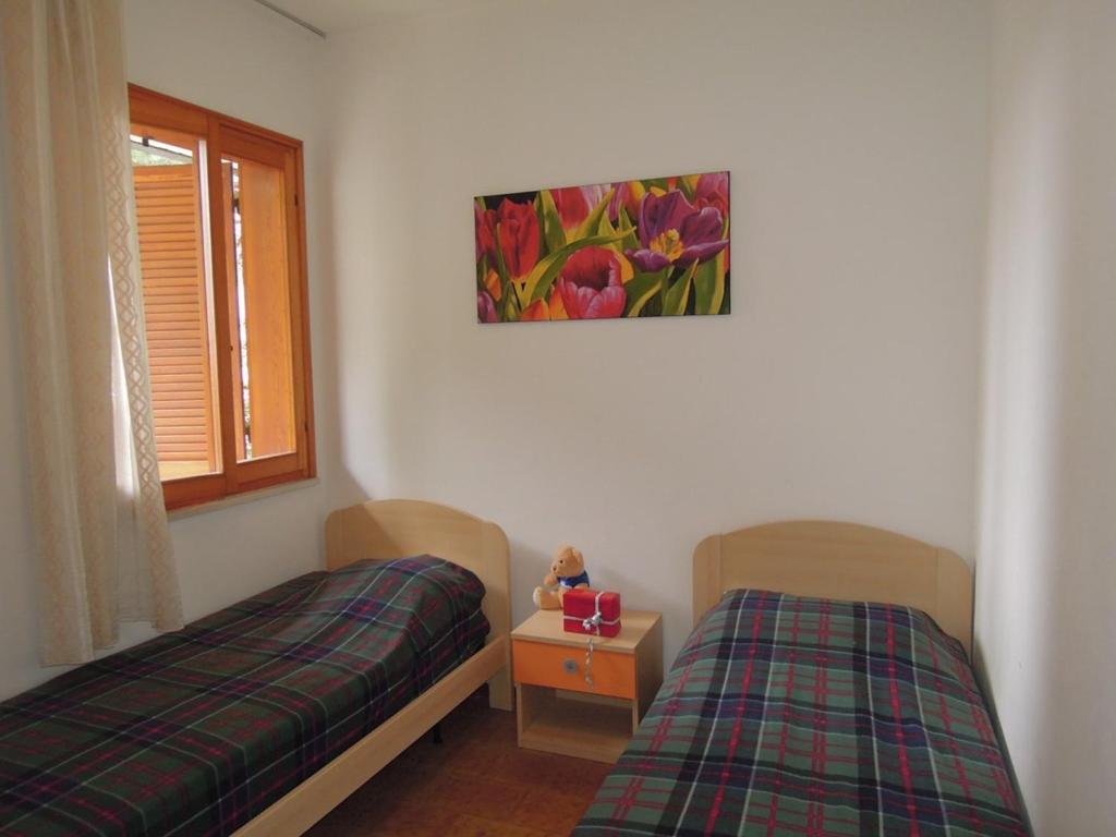 A bed or beds in a room at Villa with garden and barbeque 250m from the sea