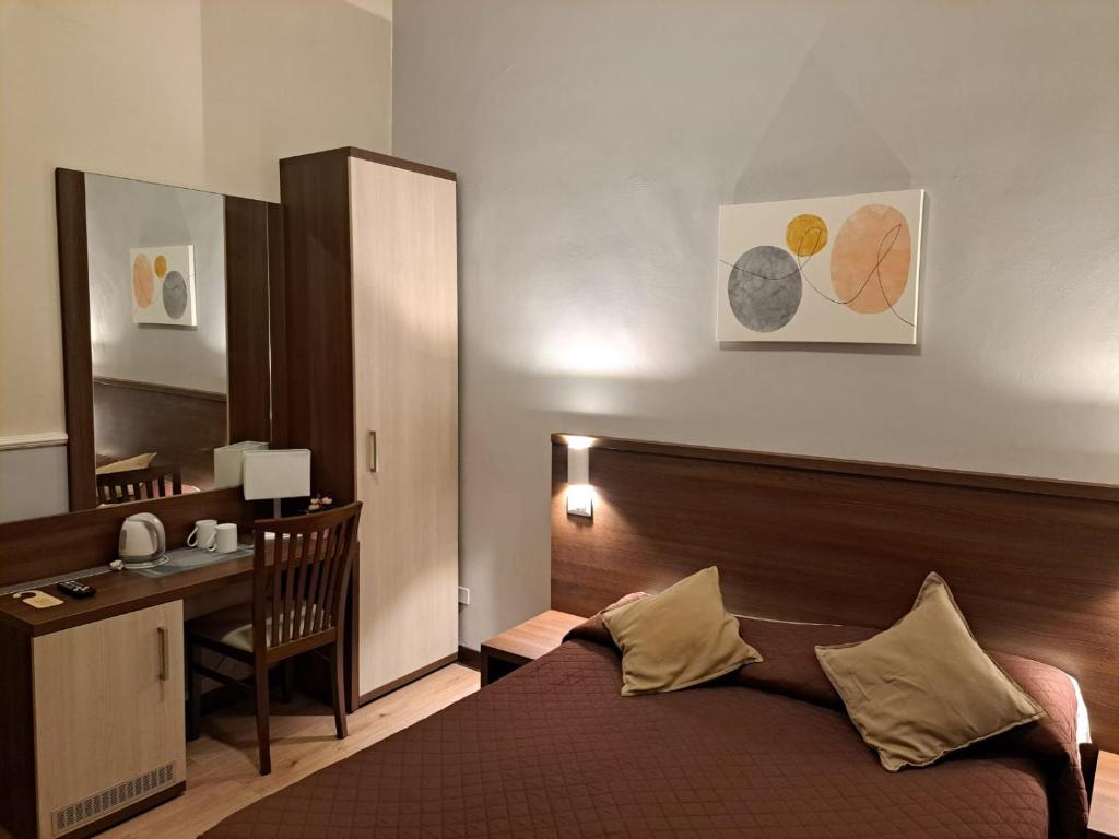 Postel nebo postele na pokoji v ubytování Hotel Leone
