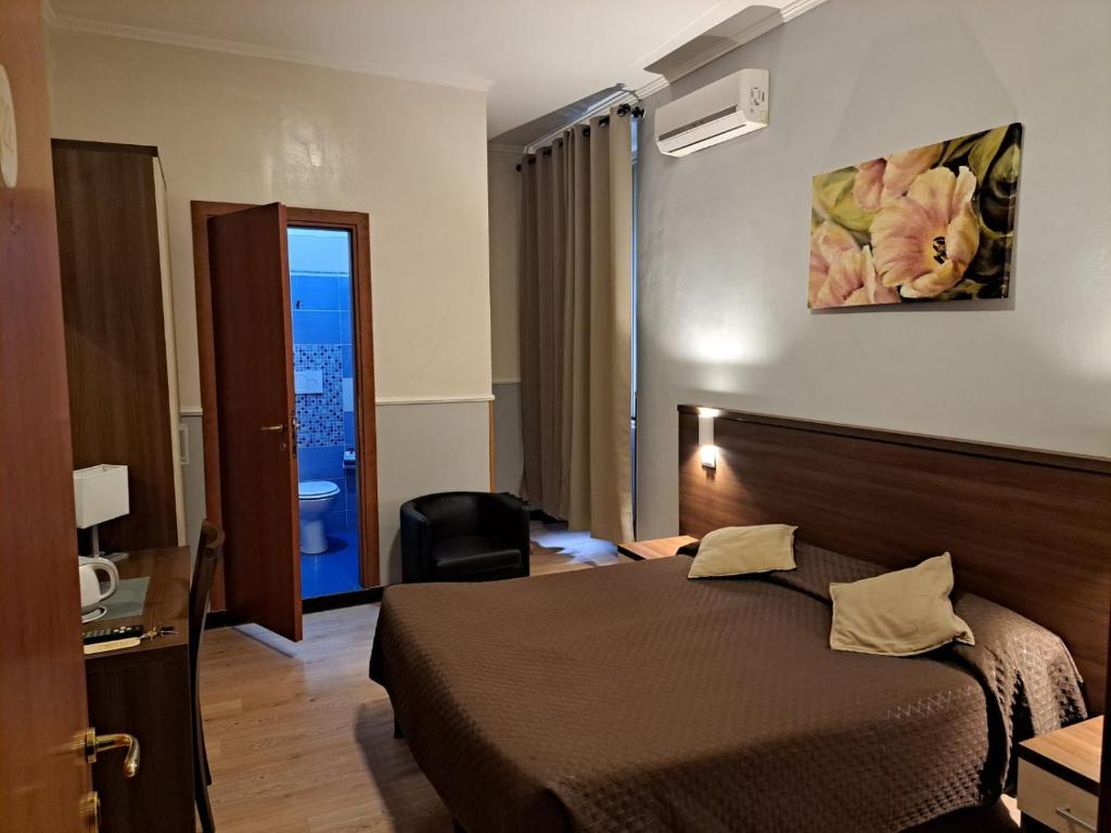 a hotel room with a bed and a bathroom at Hotel Leone in Rome