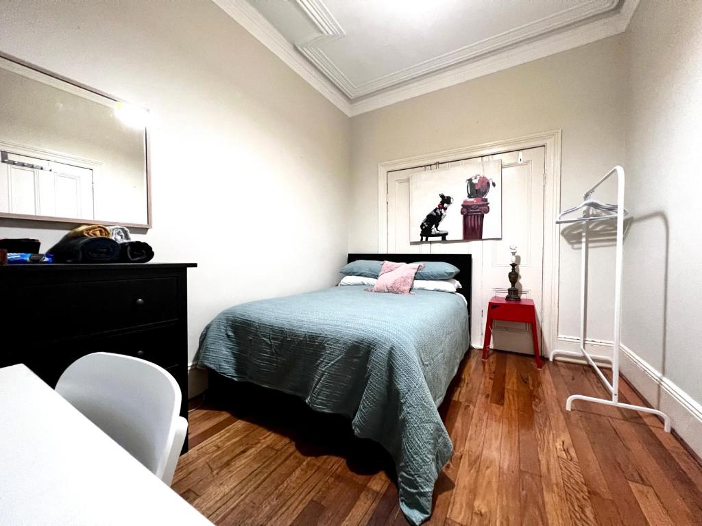 a bedroom with a bed and a dresser in it at Peaceful Haven in Sydney