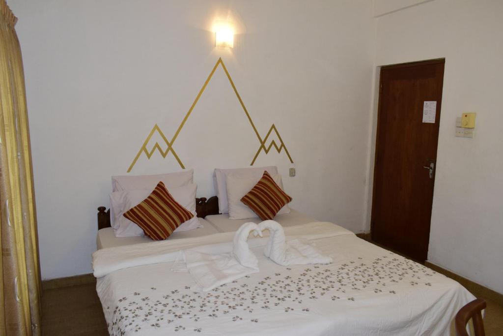 Postel nebo postele na pokoji v ubytování Paradise Inn