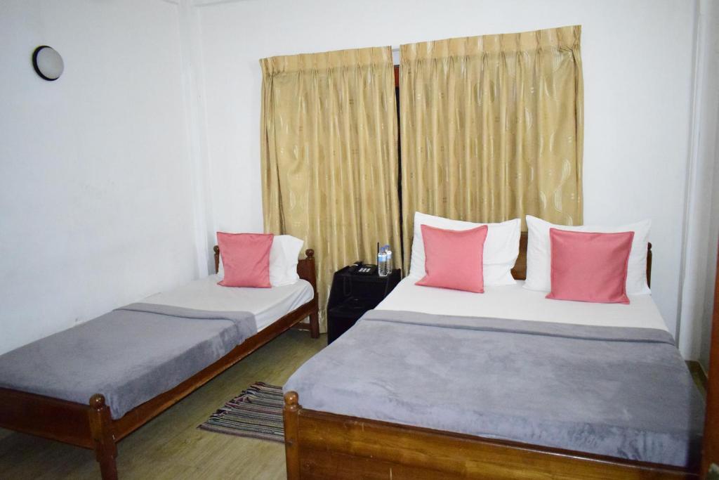 Postel nebo postele na pokoji v ubytování Paradise Inn