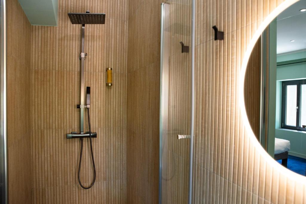 a bathroom with a shower with a shower head at Manoir le Roure in Châteauneuf-du-Rhône