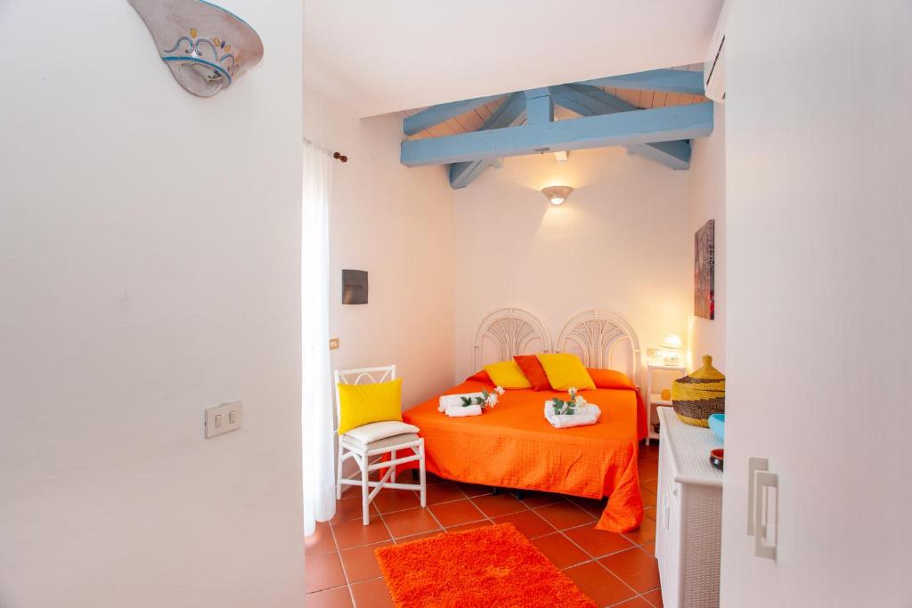 プンタルディアにあるVillino Le Luccine biloのベッドルーム1室(オレンジ色のベッド1台付)