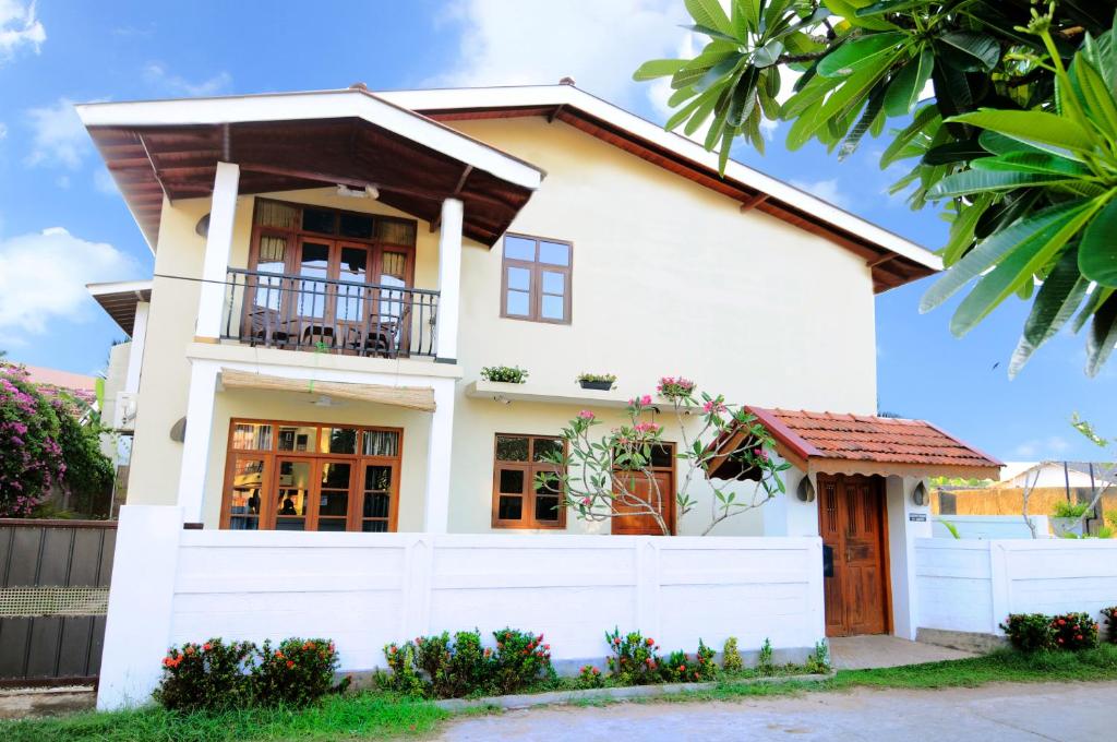 a white house with a balcony at Park Lane Apartments in Negombo